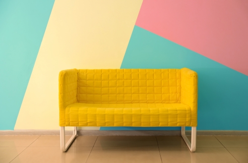 Yellow couch with bright colored background